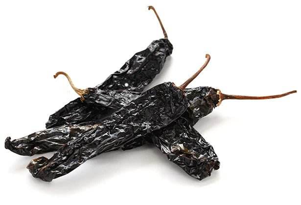 The pasilla chile or chile negro is the dried form of the chilaca chili pepper