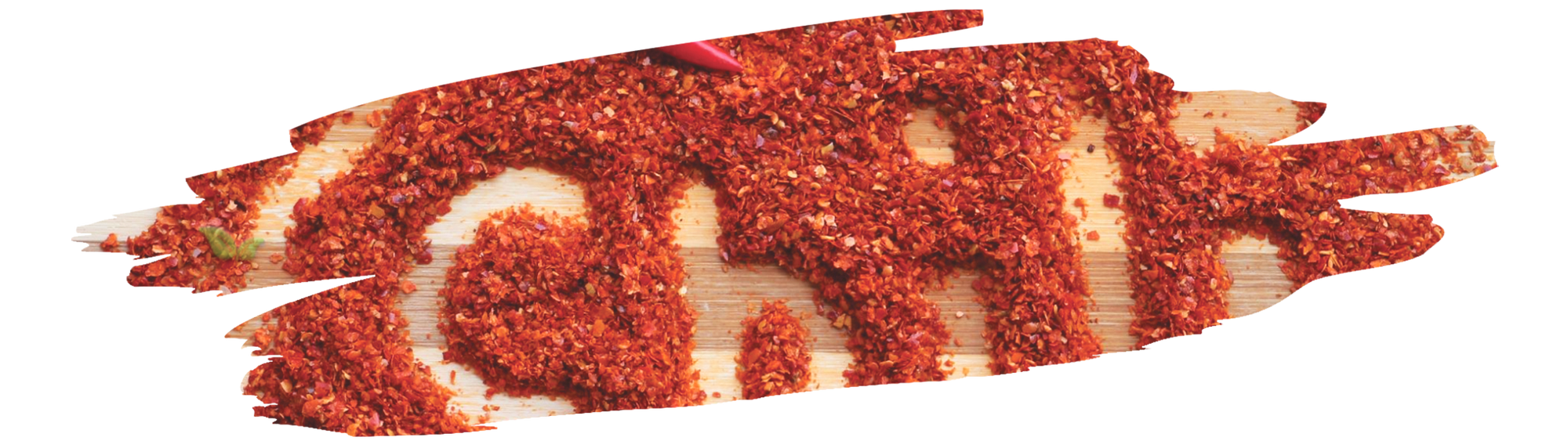 Close-up of guajillo chili showing its dark red color and smooth skin next to standard chili peppers.