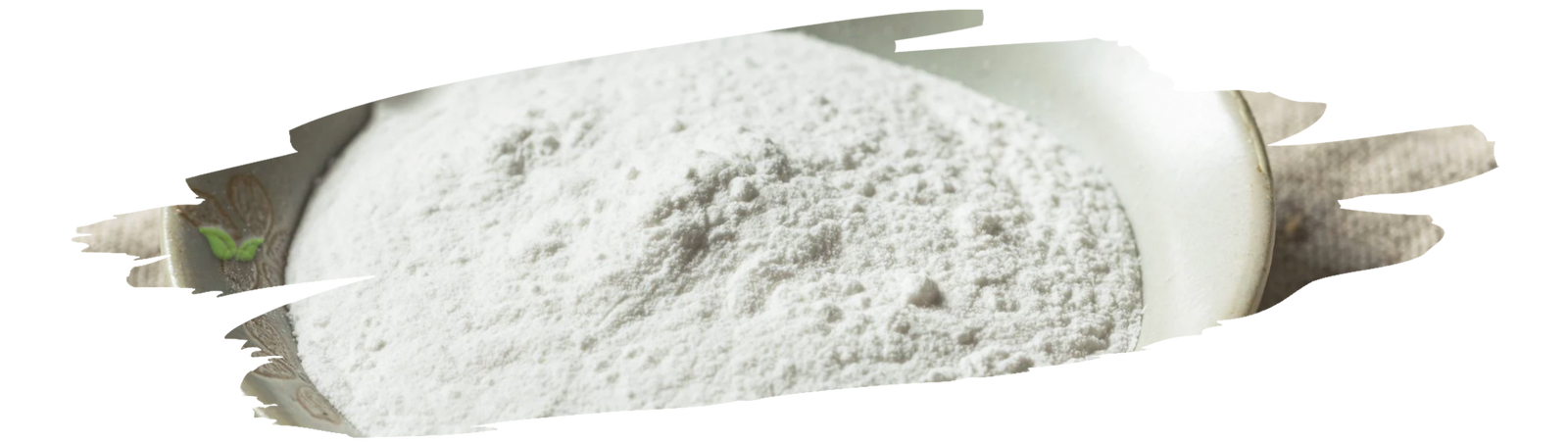 Measuring spoon with cream of tartar beside egg whites and baking tools