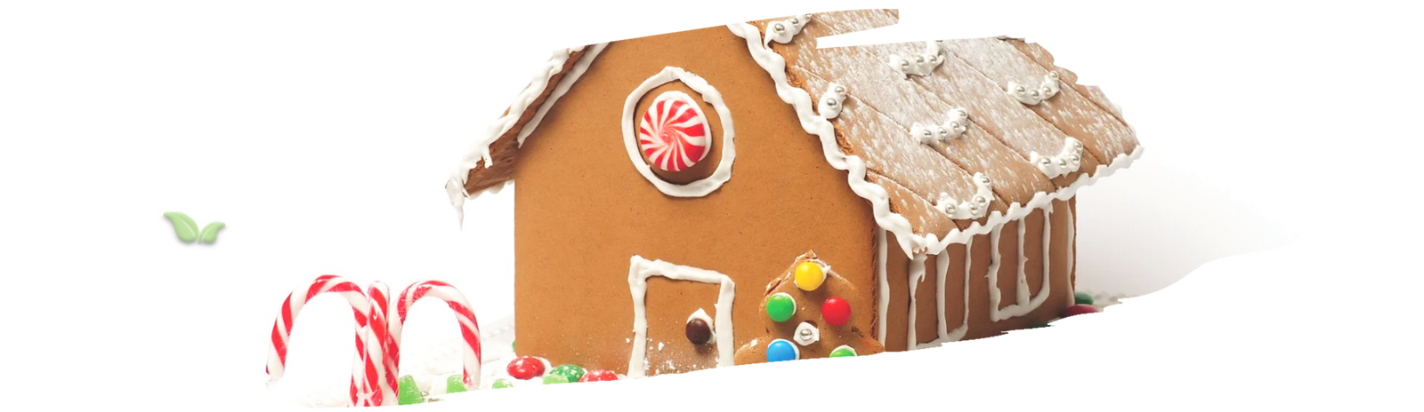 Gingerbread house decorated with colorful candies and frosting on festive table
