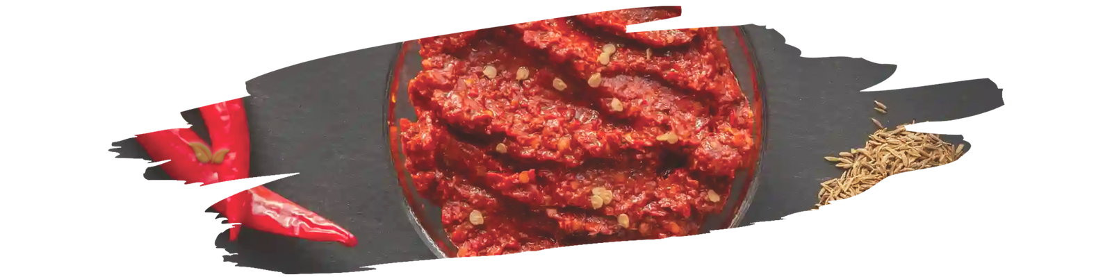 Harissa seasoning blend with chili flakes, garlic, and spices in small bowl