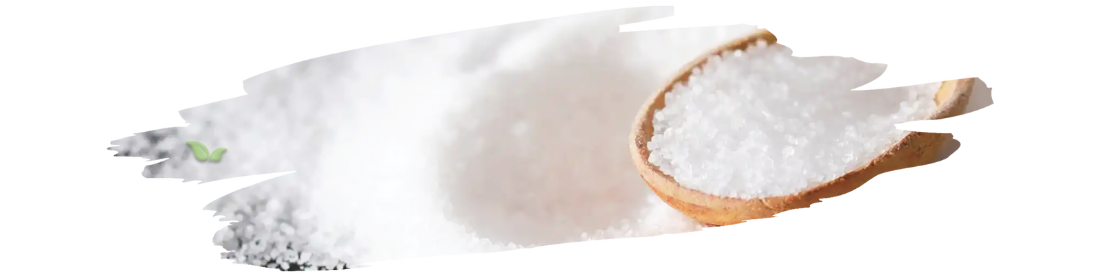 Measuring spoon with reduced salt beside fresh vegetables and seasonings.