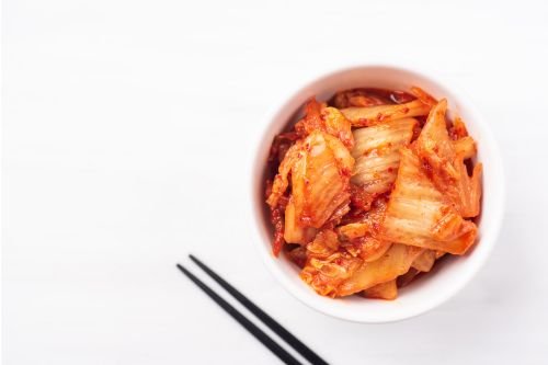 jar of homemade kimchi showing bright red color and texture