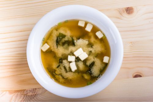 bowl of japanese miso soup showing tofu cubes and seaweed