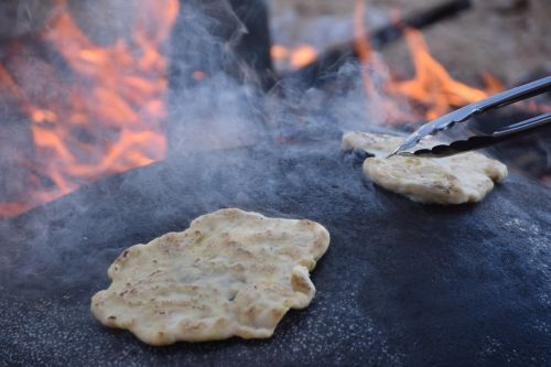 freshly baked taboon bread showing golden puffed surface
