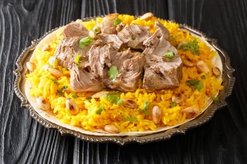 plate of jordanian mansaf showing lamb, rice, and yogurt sauce
