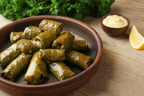 grape leaves stuffed with rice and herbs showing glossy rolled texture