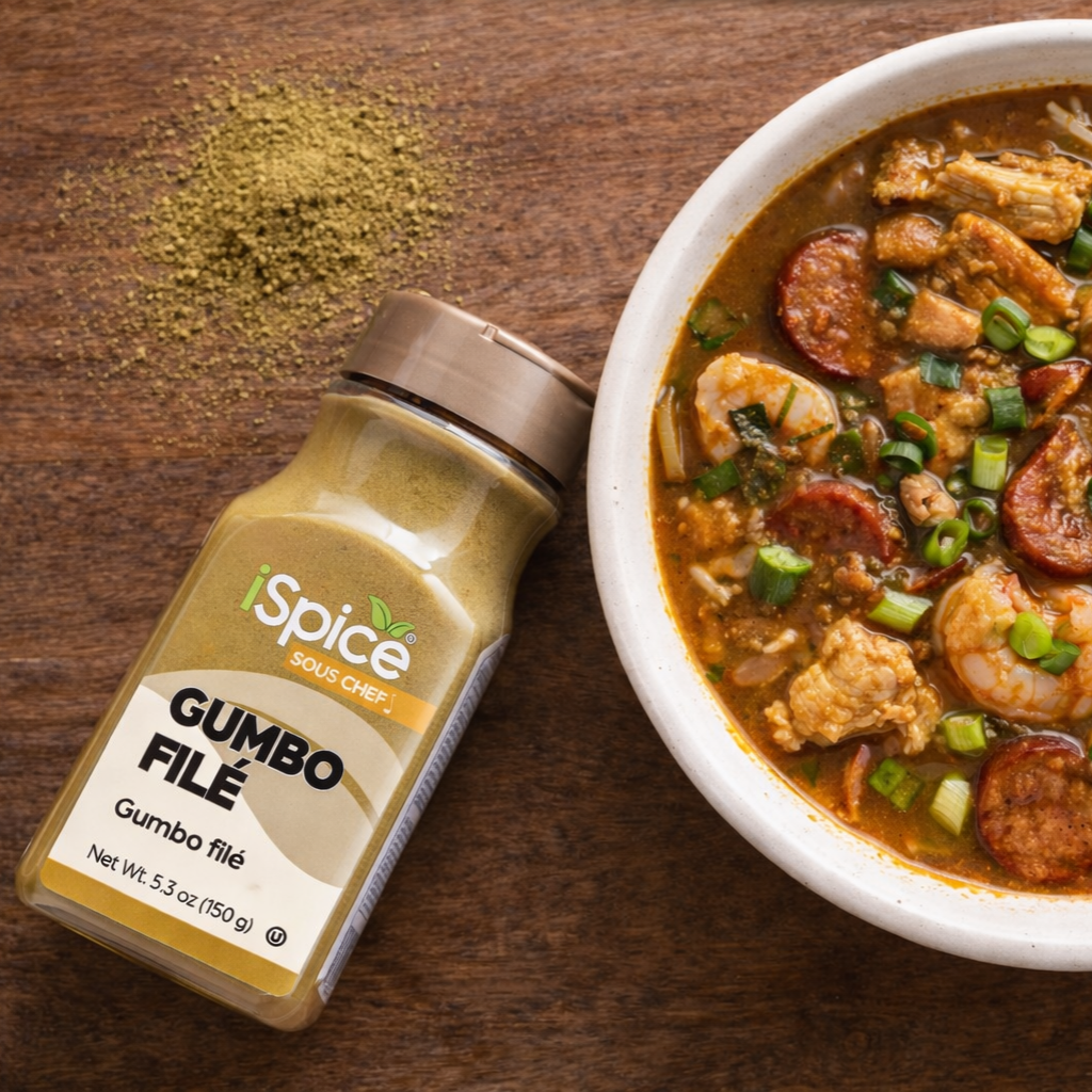 iSpice Gumbo File seasoning bottle next to a bowl of gumbo on a wooden surface