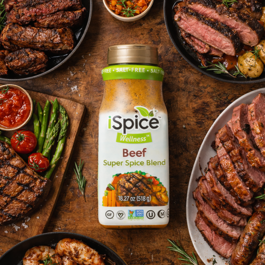 iSpice Wellness Beef Super Spice Blend bottle surrounded by grilled meats and vegetables on a wooden surface