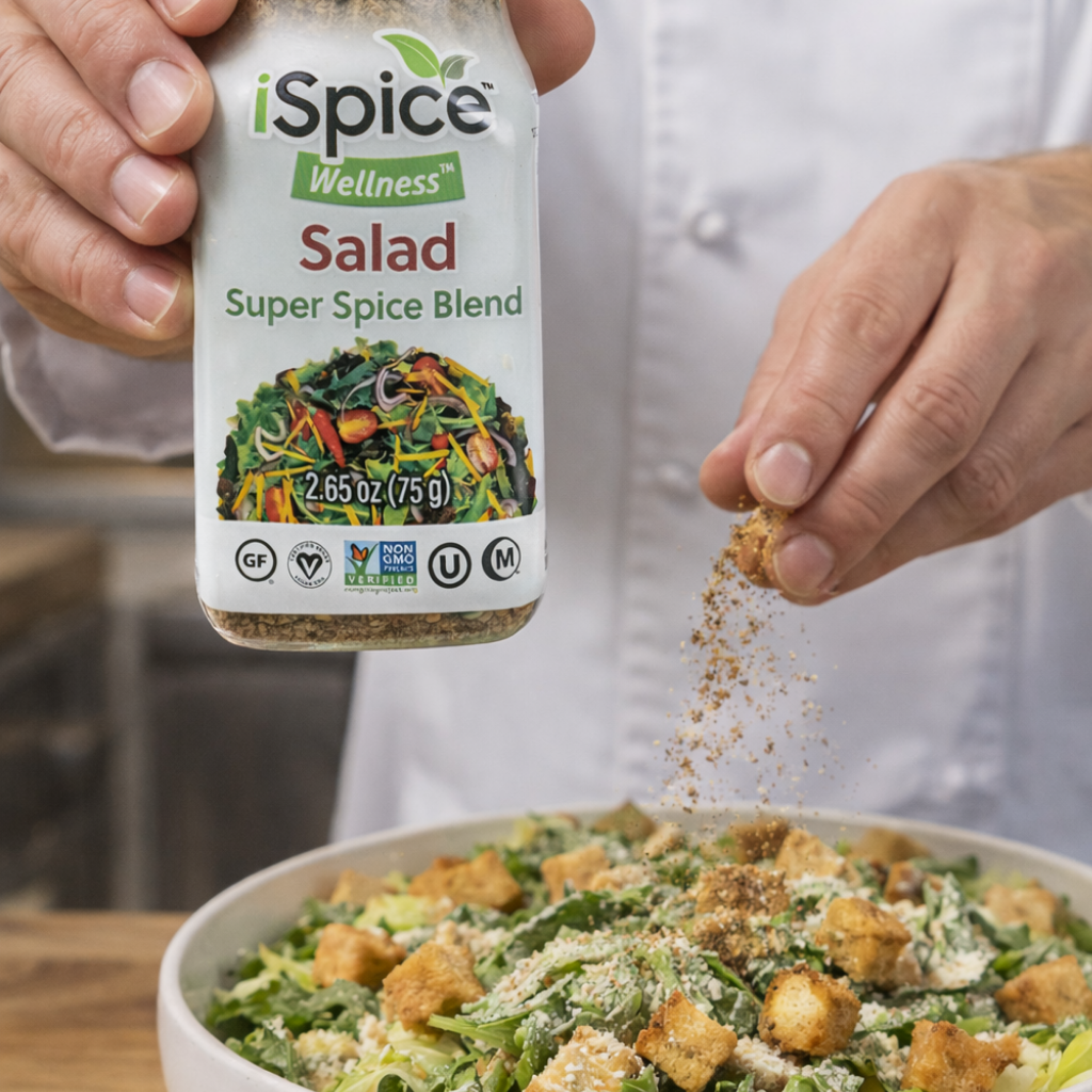 Person sprinkling iSpice Wellness Salad Super Spice Blend over a salad