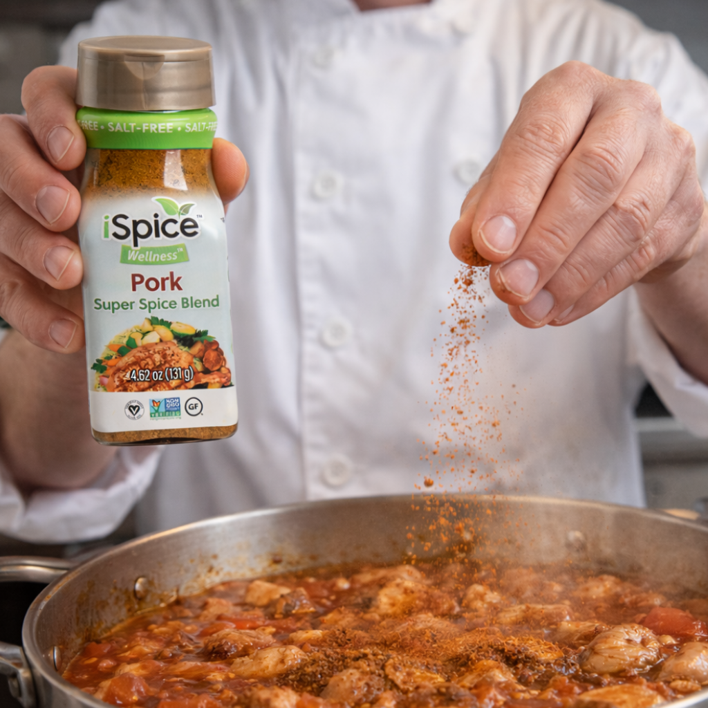 Person seasoning food in a pan with iSpice Pork Super Spice Blend