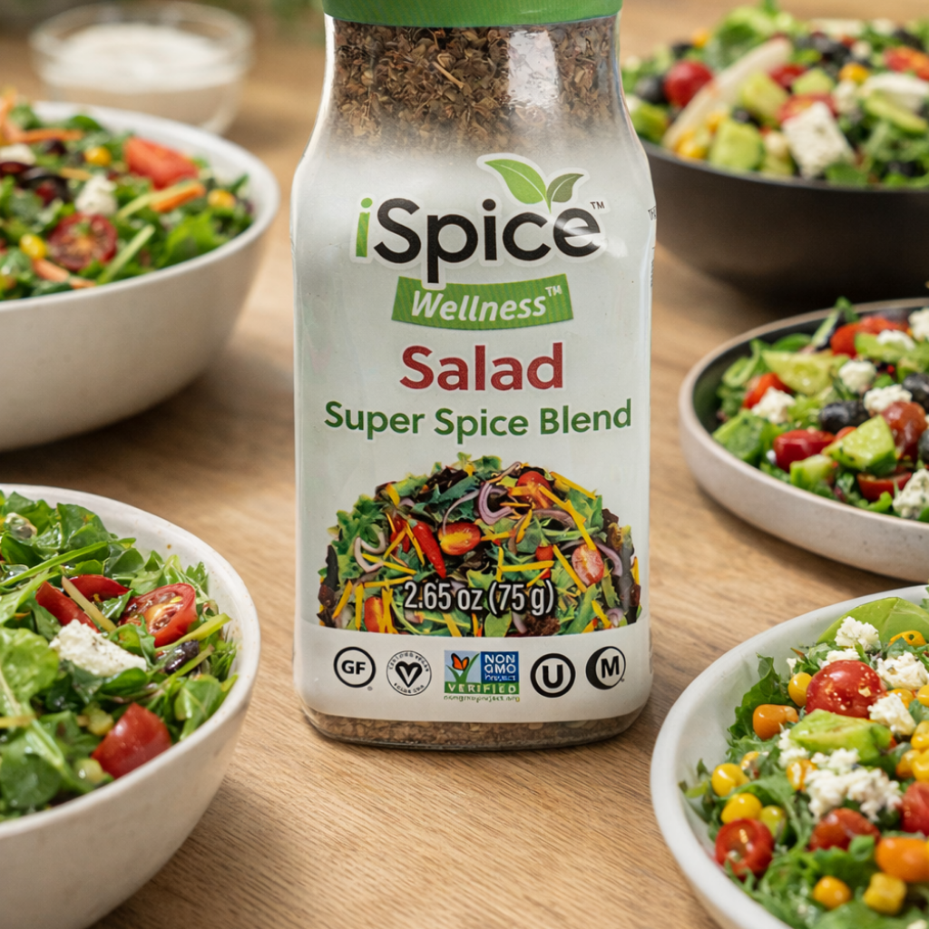 iSpice Wellness Salad Super Spice Blend bottle with salads in the background on a wooden table